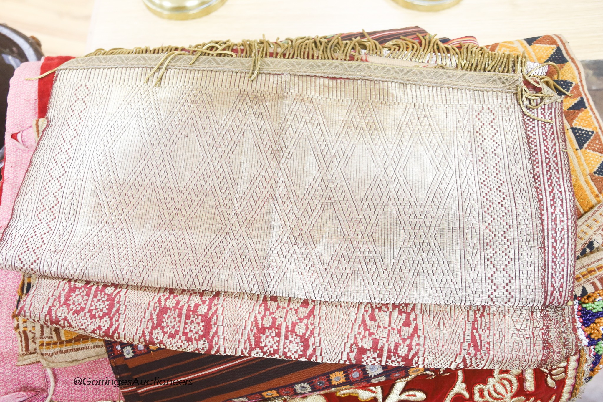 Three Indonesian bullion panels, a red velvet gold embroidered hanging, an Indian mirrored panel, etc.